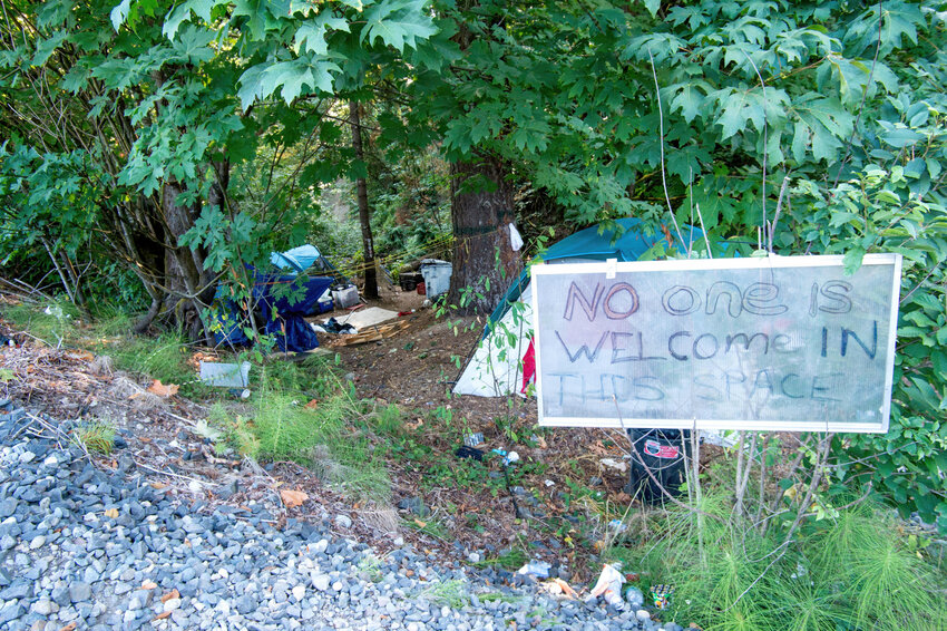 &quot;No one is welcome in this space&quot; reads a sign near the homeless encampments along Percival Creek in west Olympia.