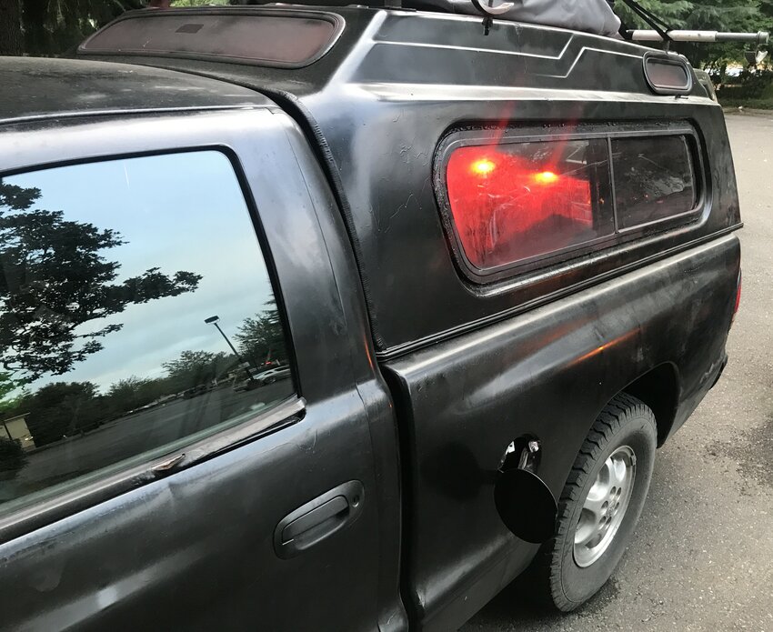 The red Dodge Dakota was spray-painted black and ignition was damaged with vice grips
