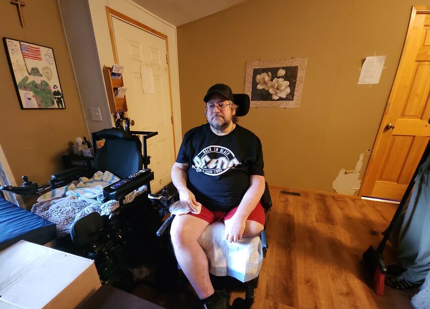 Sept. 10, 2023. Pictured here at home, in his 415-pound electric wheelchair and his all-terrain chair. Out of view were two cats who provide levity, Patches and Scooby. This laminate floor replaces his old wall-to-wall carpet. &ldquo;Look at that floor,&rdquo; Darin commented. &ldquo;It&rsquo;s beautiful&hellip; I was here most of the time and watched everything&hellip; very friendly [SPSHH] volunteers and good communicators. They always let me know what was going on with the project.&rdquo; Sept. 10, 2023.