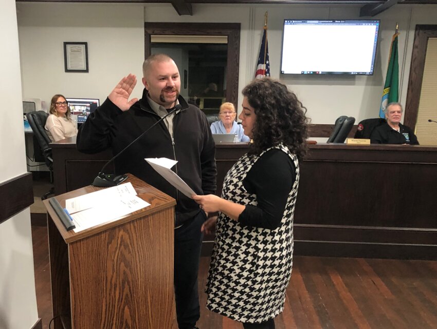 Commissioner Wayne Fournier was sworn in by Commissioner Carolina Mejia at a ceremony at Tenino City Hall on November 28, 2023. Shown behind the commissioners are Tenino officials, including Clerk-Treasurer Jen Scharber and Councilmembers Elaine Klamn and John O'Callahan.