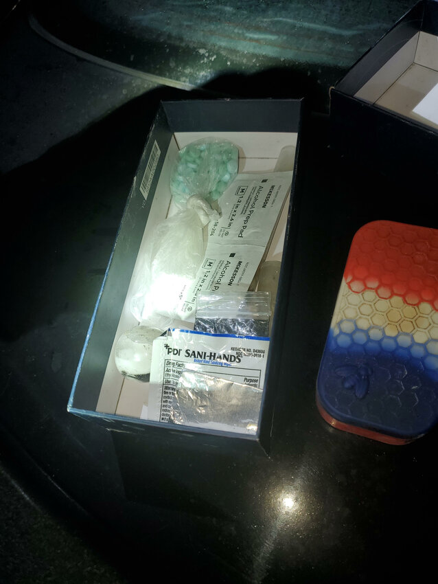 Narcotics paraphernalia, a container with heroin inside, a bag of over 40 blue and green fentanyl pills inside, a bag with a large chunk of cocaine, a black digital scale with methamphetamine and other narcotics residue on it, and $2011 were found inside the car of the suspect.
