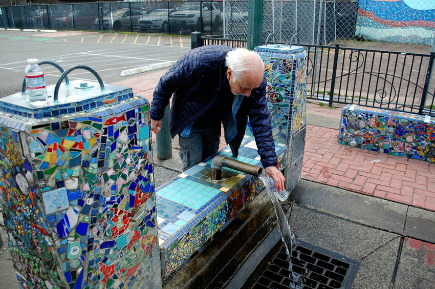 Tumwater resident Donnie Thompson fills  water bottles at a free public well in Olympia's Artesian Commons park. The well is one of many artesian springs located in Thurston County, which for over a century has been renowned for the quality of its water. The discovery of carcinogenic 