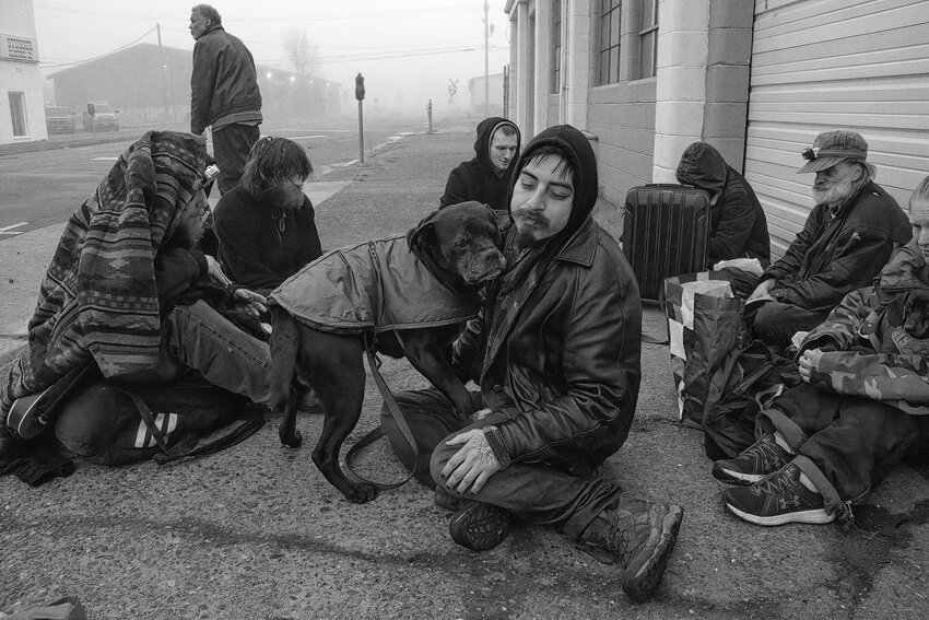 Hollywood the Dog snuggles up with homeless owner Prince on a foggy Saturday morning recently.