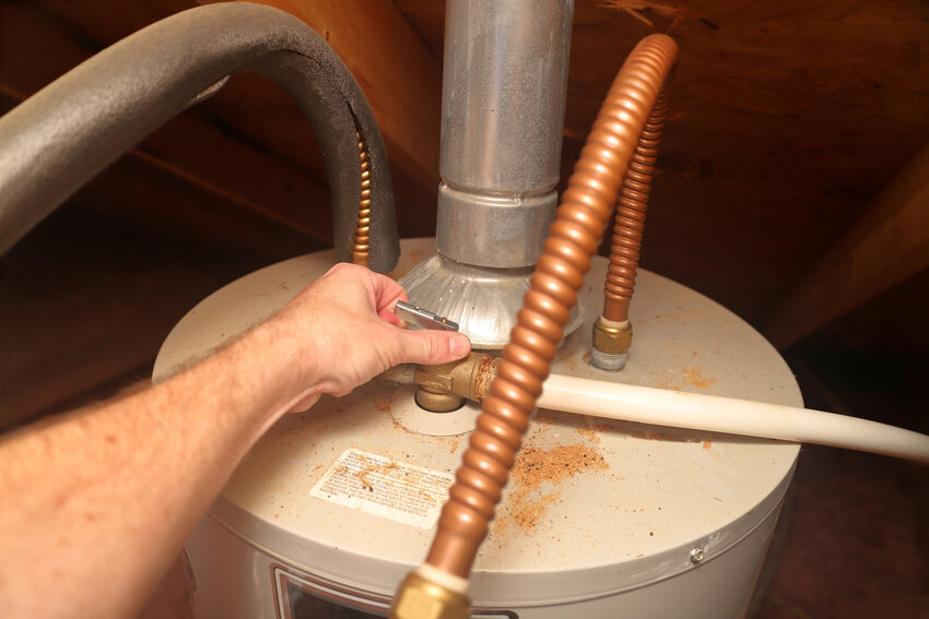 Water Heater - hand releases T&amp;P safety Relief Valve on a home water heater