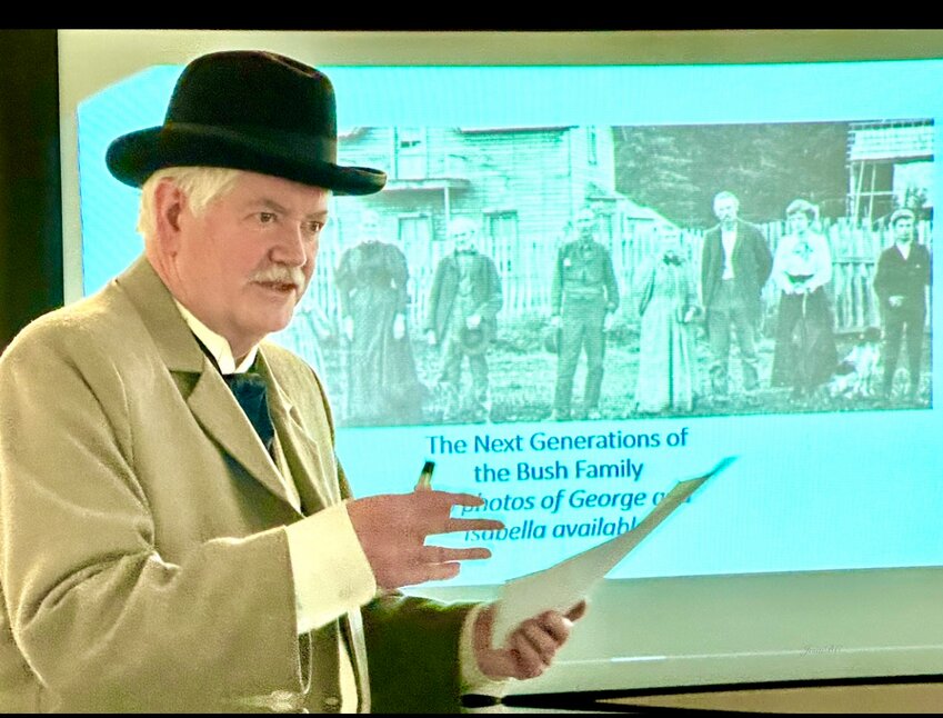 Don Trosper in costume with the Heritage Builder slide at the Daughters of the American Colonists presentation in Tumwater.