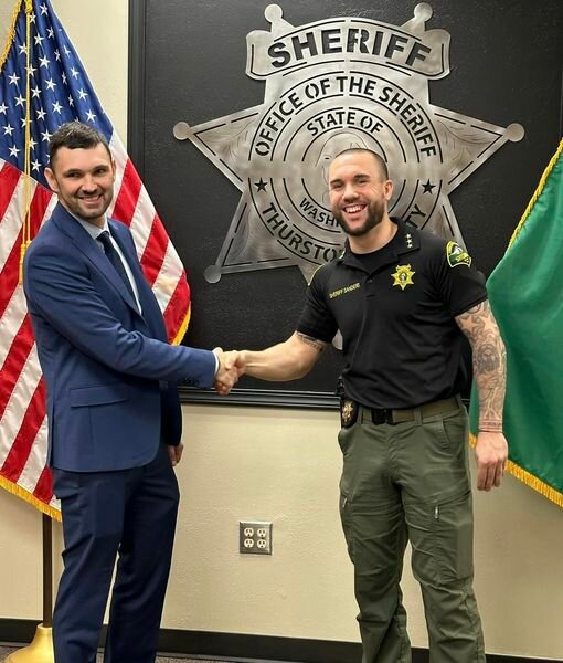Christopher Burbank (left) with Thurston County Sheriff Derek Sanders during Burbank's oathtaking ceremony as a deputy last Monday, April 1, 2024.