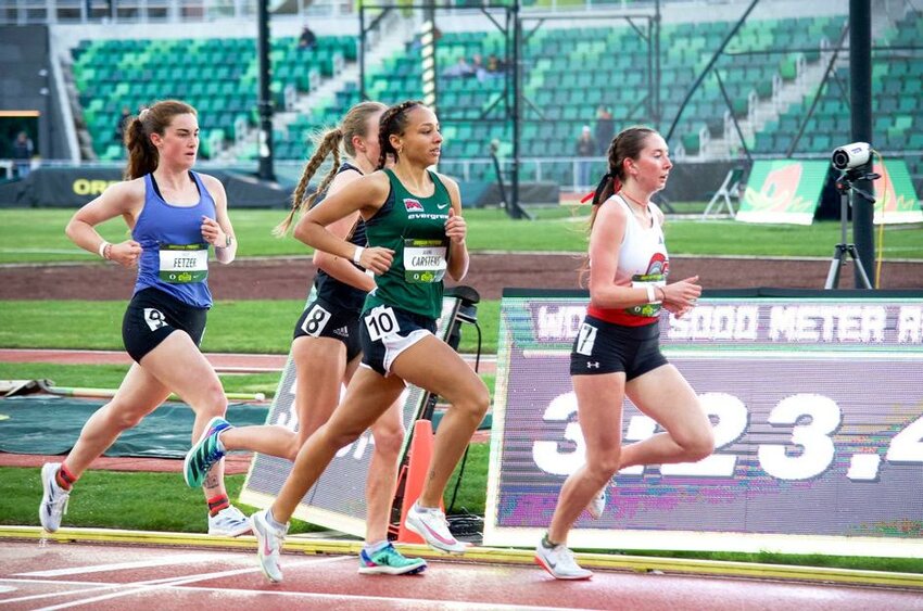 Alauna Carstens (in green) books her tickets to the conference and national championships in women&rsquo;s 1500 meters, her second national standard.