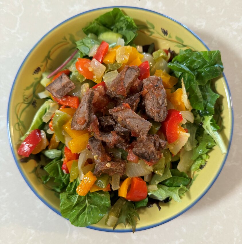 Steak fajita salad is easy to make and a good way to deal with various leftovers.