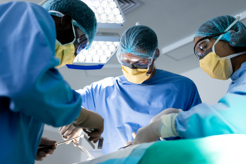 A diverse group of surgeons performing surgery