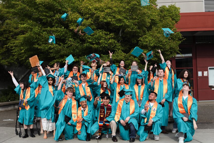Envision  Career Academy's Class of 2024 graduates celebrate their graduation with the traditional tossing of the caps into the air.