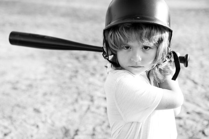 A small girl ready to play softball