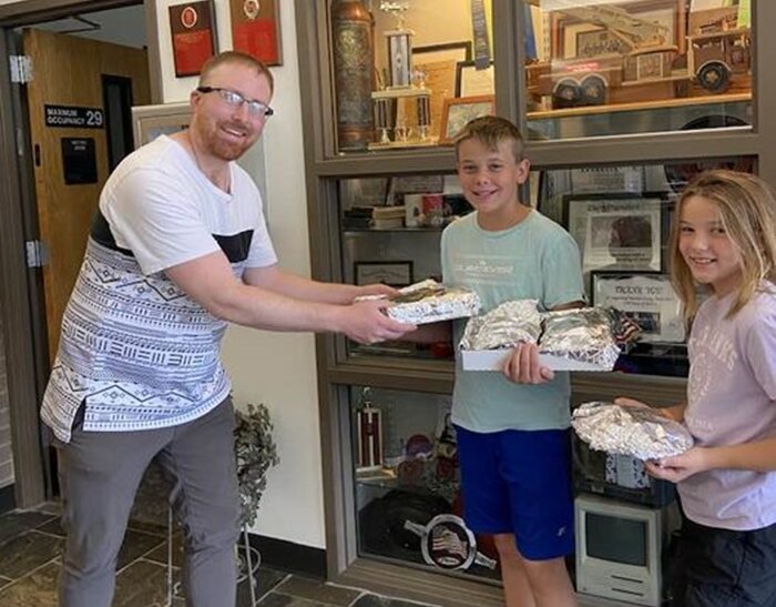South Bay Fire Station 81 Volunteer Tyler Barthule is accepting treats baked by Kathleen's grandson-in-law's children, Quinton and Dovey Mayes.