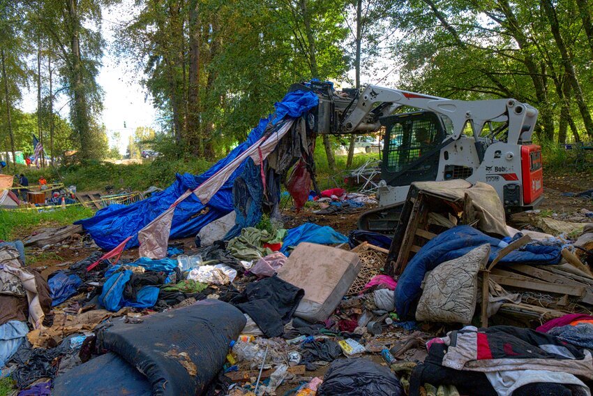 BEFORE: Contractors used heavy machines to scoop up and remove large amounts of trash.