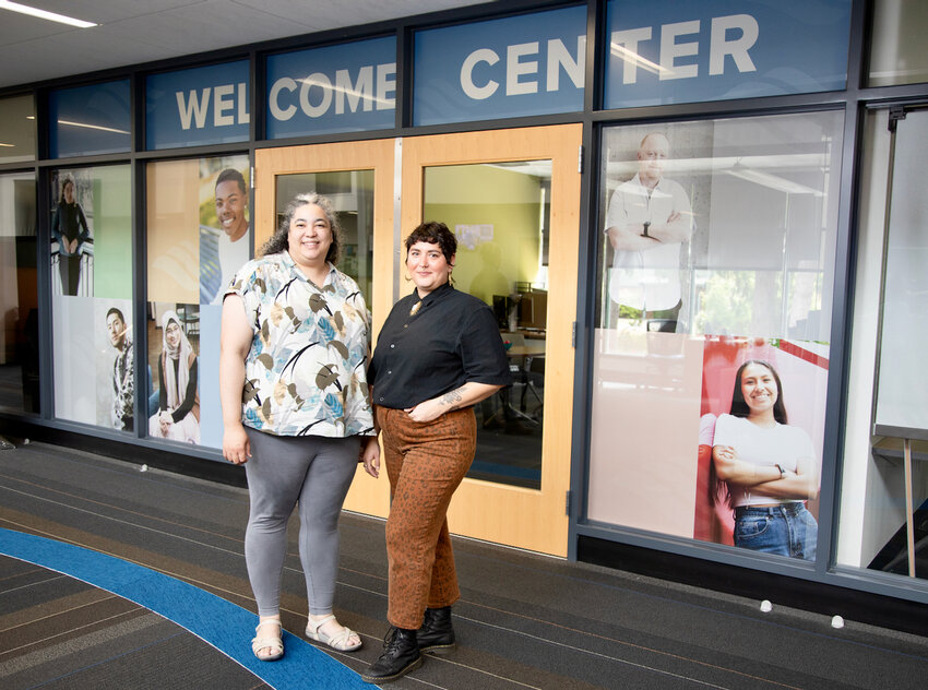 South Puget Sound Community College staff members Erin Rust and Teal Farias, as seen in front of the new Welcome Center at the college.