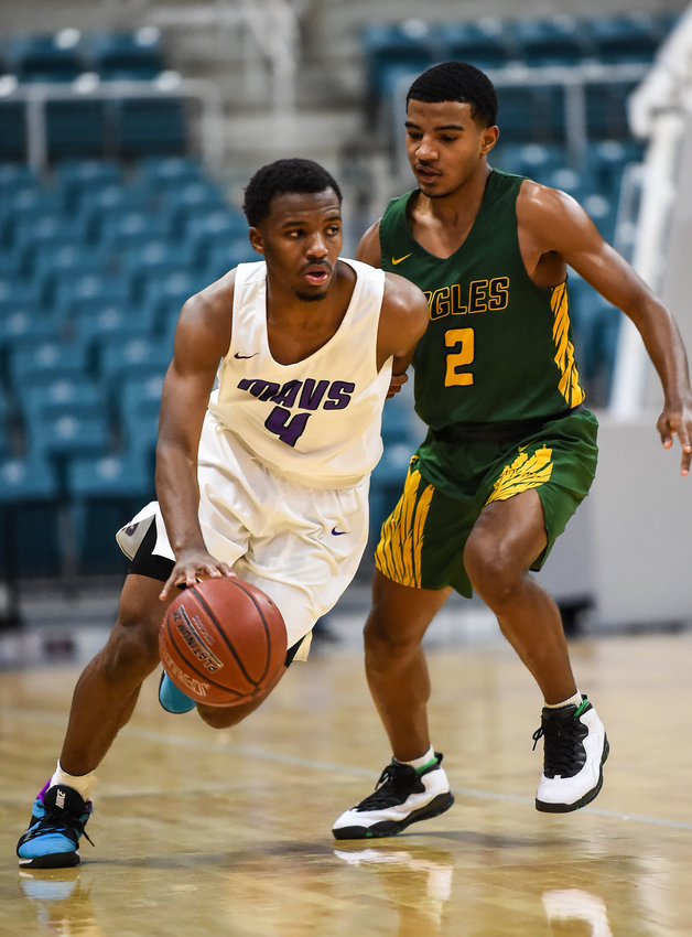 Katy Tx. Dec 7, 2019: Morton Ranch's LJ Cryer (4) drives past Klein Forest's Marion Williams (2) during the Katy Classic at the Merrell Center.  (Photo by Mark Goodman / Katy Times)