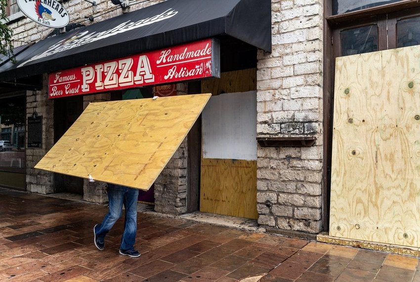 Workers boarded up bars on Sixth Street in Austin after Gov. Greg Abbott closed bars in Texas for the second time in three months because of the COVID-19 pandemic on June 26, 2020.