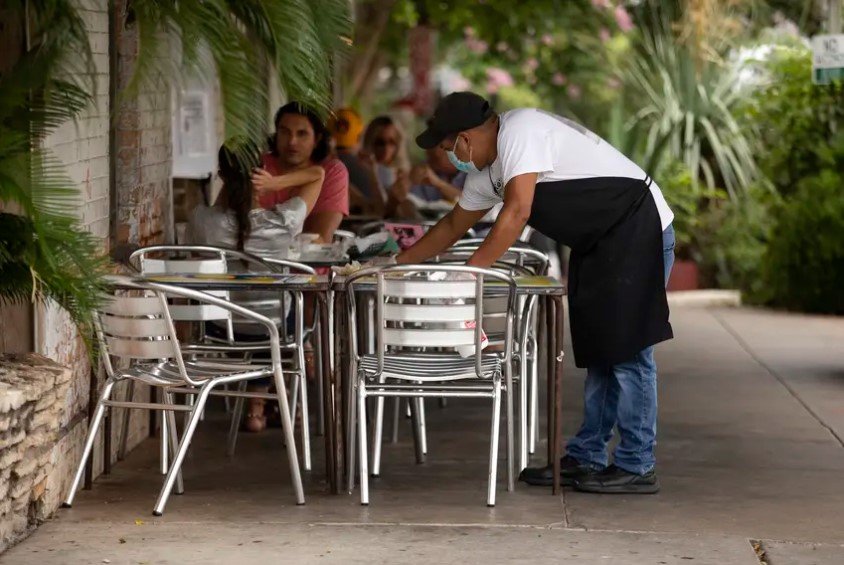 Texas collected $2.98 billion in sales tax revenue in July &mdash; 4.3% more than in July 2019. Comptroller Glenn Hegar said the number was &quot;better than expected.&quot; In this photo, an employee cleans a table at Gueros Taco Bar in South Austin. Restaurants contribute to sales tax revenue.