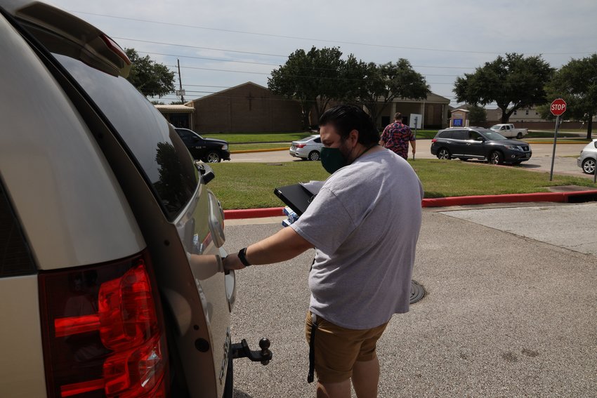 Katy ISD staff brought devices out to vehicles for curbside pick up on Monday, Aug. 17. About half of the district&rsquo;s student body will continue to take online classes through the Katy Virtual Academy after students are allowed to - tentatively - return to campuses Sept. 8.