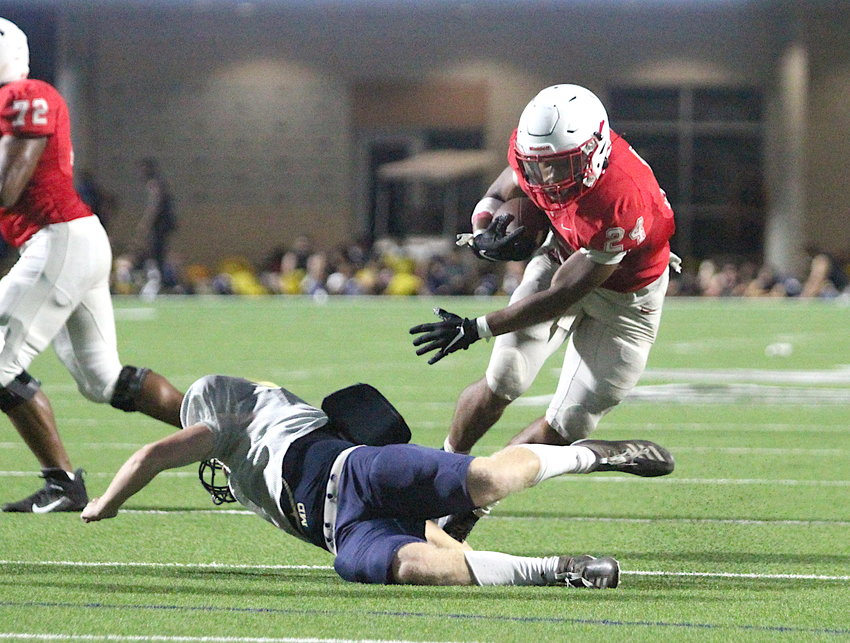 Football returned to the Katy area last night with teams participating in their first and only interscholastic scrimmage ahead of the delayed regular-season opener next Friday. The Katy Tigers hosted the Klein Collins Tigers at Legacy Stadium and will travel to play Clear Springs next week. Pictured is Katy running back Jalen Davis making a Klein Collins defender miss in the red zone.