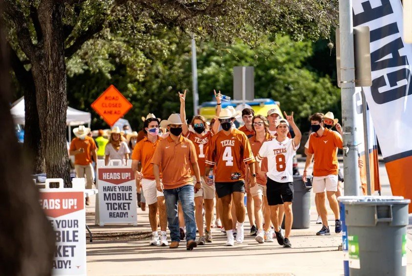 Fans walk toward the stadium for the first home football game of the season at the University of Texas at Austin. Students had to test negative for the coronavirus before attending the game. In counties where four-year college students make up at least 10% of the population, cases have grown 34% since Aug. 19, according to a Texas Tribune analysis. That&rsquo;s compared with 23% in counties with a smaller proportion of students.