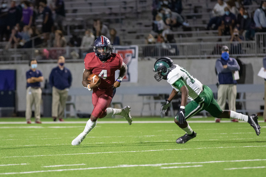 Tompkins quarterback Jalen Milroe eludes defenders during the Falcons' win over Mayde Creek on Thursday evening at Legacy Stadium.