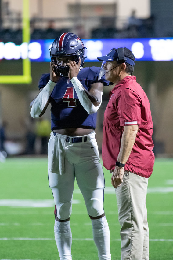 Tompkins senior quarterback Jalen Milroe, left, and Tompkins head coach Todd McVey talk during a game earlier this season at Legacy Stadium. Milroe was named District 19-6A&rsquo;s Most Valuable Player and McVey was named the district&rsquo;s Coach of the Year.