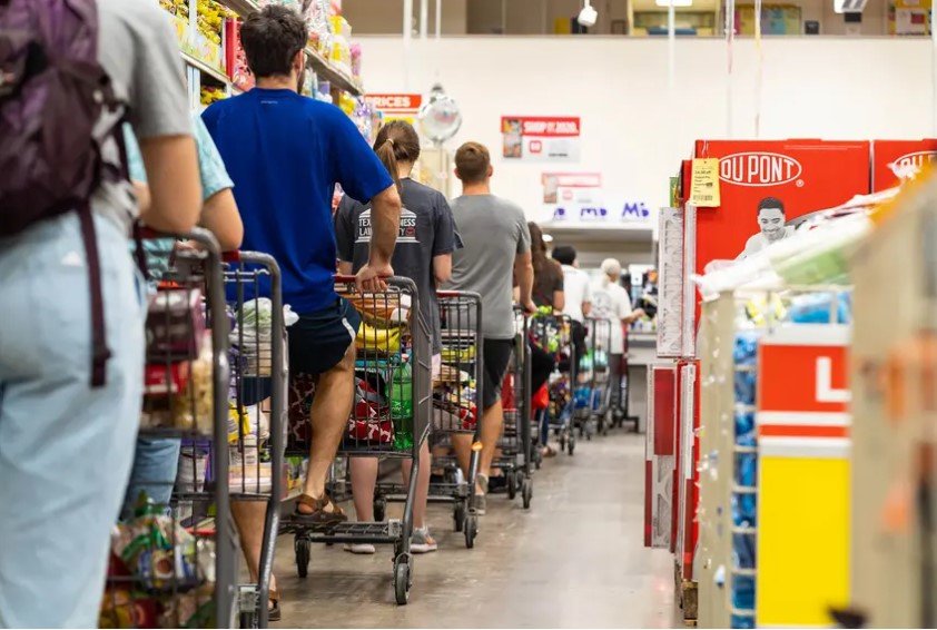Grocery shoppers formed a long line at the H-E-B grocery store at Hancock Center in Austin last year. Grocery store employees were called essential when the pandemic began, but haven't been given priority access to the coronavirus vaccine.