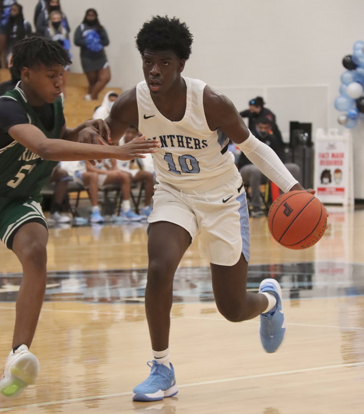 Paetow junior forward Idy Igbaroola (10) handles the ball against defensive pressure during the Panthers&rsquo; game against Bryan Rudder on Saturday, Feb. 6, at Paetow High.
