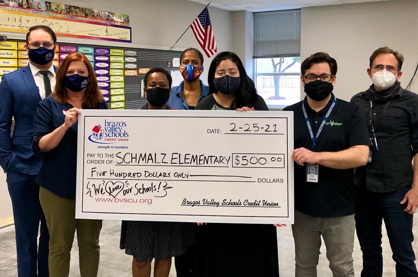 BVSCU staff present Schmalz Elementary School Principal Charlotte Gilder (third from left) with a check for $500 to support the recovery of the school&rsquo;s music program after burst pipes caused damage to the campus the week of Feb. 14.