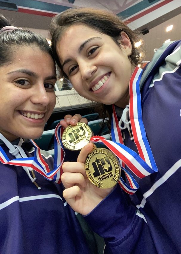 Morton Ranch sisters Brittany and Rachel Cotter pose for a photo Saturday, April 17, after they won their respective weight class divisions at the Class 6A Region III wrestling meet at the Merrell Center.
