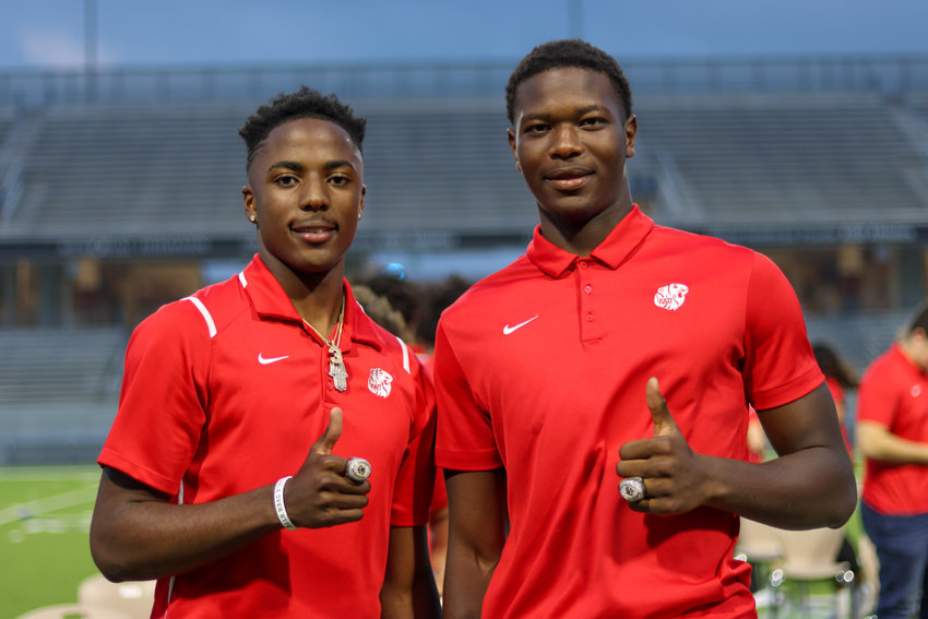 Katy High juniors Bobby Taylor, left, and Malick Sylla show off their 2020 state championship rings after a celebratory ceremony Monday, May 3, at Legacy Stadium.