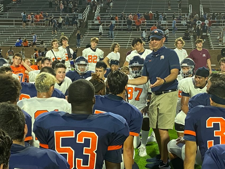 Seven Lakes coach Jimmy Hamon talks to his players following their spring football game Thursday, May 20, at Rhodes Stadium.