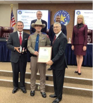 State Trooper Drew Stoner of Rosenberg is presented with the Medal of Valor by DPS Director Steven McGraw (right, front) during an Aug. 12 ceremony in Austin. Stoner witnessed a shooting and provided aid to one of the victims after arresting the perpetrator this past Feb. 20 near his home.