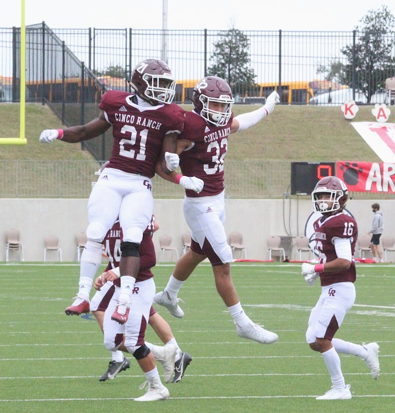 Two Cinco Ranch players celebrate during a game against Katy High last season.