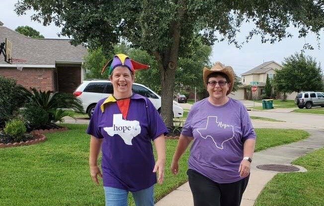 Two participants in Relay for Life Katy take a lap during a prior year&rsquo;s event. Laps around the various relay locations are made in honor of survivors, caregivers, supporters, those who lost their lives to cancer &ndash; or sometimes, just as an excuse to wear a silly hat and have fun while supporting a good cause.