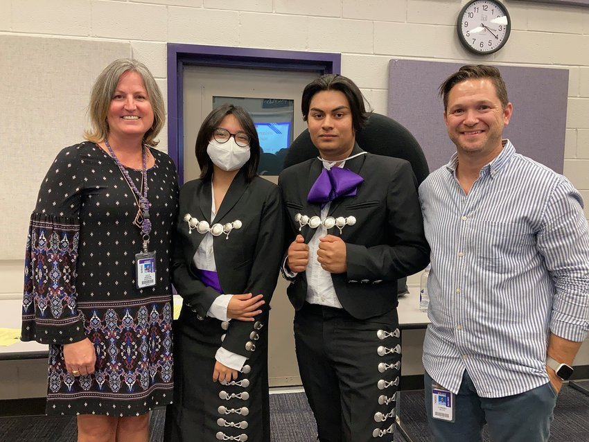 (From left to right) Morton Ranch High School Principal Julie Hinson, mariachi players Evelyn Garcia and Pedro Barrera and Director of Orchestras Gabriel Katz pose for a photo on Aug. 27. Garcia and Barrera pose in new mariachi uniforms provided by Hinson for the school&rsquo;s latest music project which endeavors to celebrate the campus&rsquo;s diverse student body.