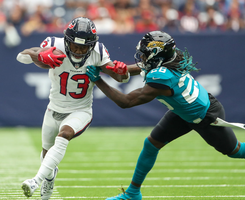 Houston Texans wide receiver Brandin Cooks (13) carries the ball as Jacksonville Jaguars cornerback Shaquill Griffin (26) attempts a tackle during the first half of an NFL game between the Houston Texans and the Jacksonville Jaguars on September 12, 2021 in Houston, Texas.