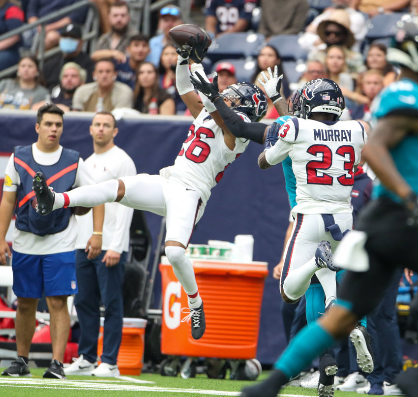 Houston Texans cornerback Vernon Hargreaves III (26) leaps to intercept a pass thrown by Jacksonville Jaguars quarterback Trevor Lawrence (16) during the first half of an NFL game between the Houston Texans and the Jacksonville Jaguars on September 12, 2021 in Houston, Texas.
