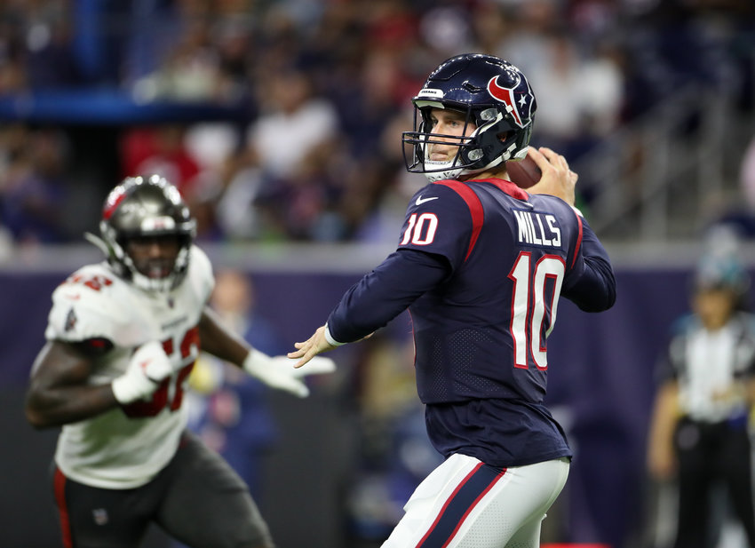 Houston Texans quarterback Davis Mills (10) drops back to pass during an NFL preseason game between the Houston Texans and the Tampa Bay Buccaneers on August 28, 2021 in Houston, Texas.