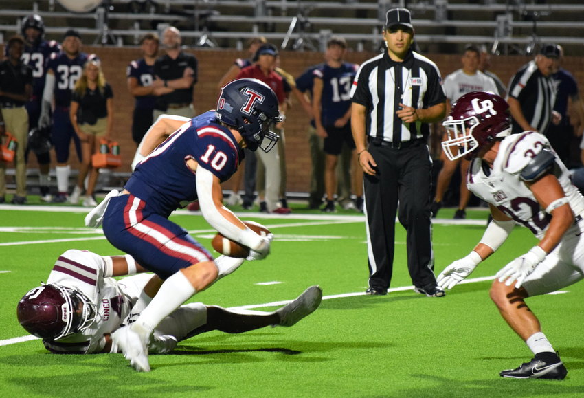Tompkins&rsquo; Wyatt Young tries to break away from Cinco Ranch defenders during a District 19-6A game at Rhodes Stadium on Thursday.