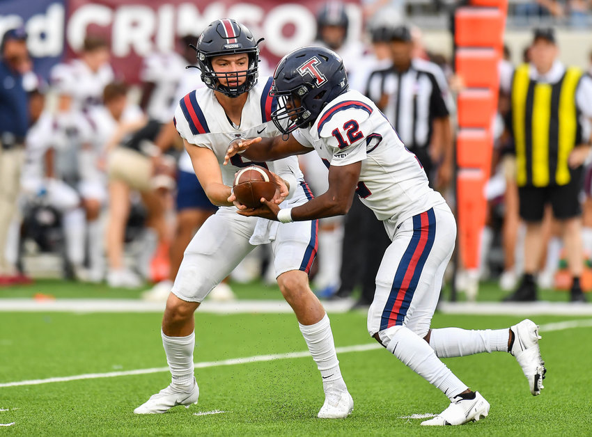 Katy, Tx. Oct 1, 2021: Tompkins #9 Cole Francis hands the ball off to #12 Collin Marshall during a game between Katy Tigers and Tompkins Falcons at Legacy Stadium in Katy. (Photo by Mark Goodman / Katy Times)