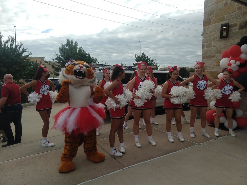 The Katy Tiger cheer squad jazzes up the crowd at the ribbon cutting for Old Chicago Pizza &amp; Taproom on Oct. 11. The ceremony was just one part of SPB Hospitality&rsquo;s big news for the Katy area after it opted to move its corporate office from Denver, Col. to Texas which will bring hundreds of jobs to the community.