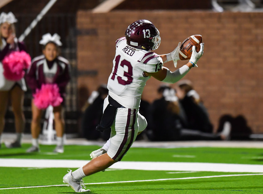 Katy, Tx. Oct 29, 2021:  Cinco Ranch's Fischer Reed #13 makes the reception scoring a TD during a conference game between Cinco Ranch and Morton Ranch at Rhodes Stadium. (Photo by Mark Goodman / Katy Times)