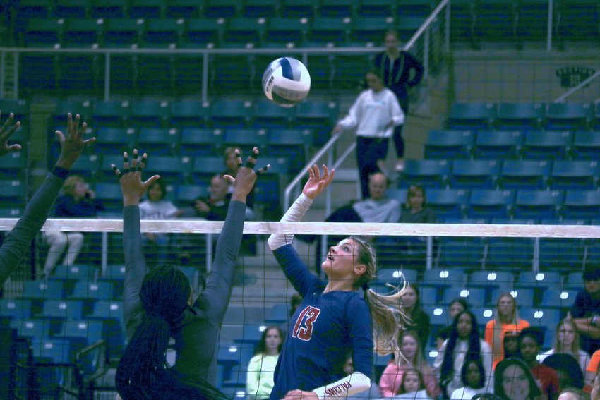 Tompkins&rsquo; Paris Herrman tips a ball over the net during Monday&rsquo;s Class 6A regional quarterfinal match against Ridge Point at the Merrell Center.