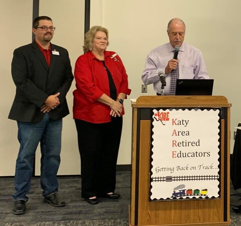 Katy Mayor Bill Hastings (at podium) reads a declaration in honor of the Katy Area Retired Educators&rsquo; twentieth anniversary while Mayor Pro Tem Chris Harris (left) and KARE President Earlene Hopkins (center) listen. KARE was founded in 2001 with the mission to support retirees who had worked for educational institutions and students within Katy ISD.
