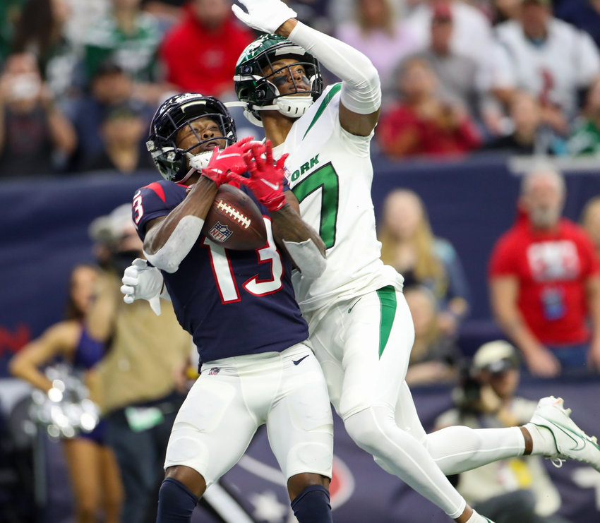 Houston Texans wide receiver Brandin Cooks (13) hauls in a 40-yard touchdown pass through the interference of New York Jets cornerback Bryce Hall (37) during an NFL game between the Houston Texans and the New York Jets on November 28, 2021 in Houston, Texas. The Jets won, 21-14