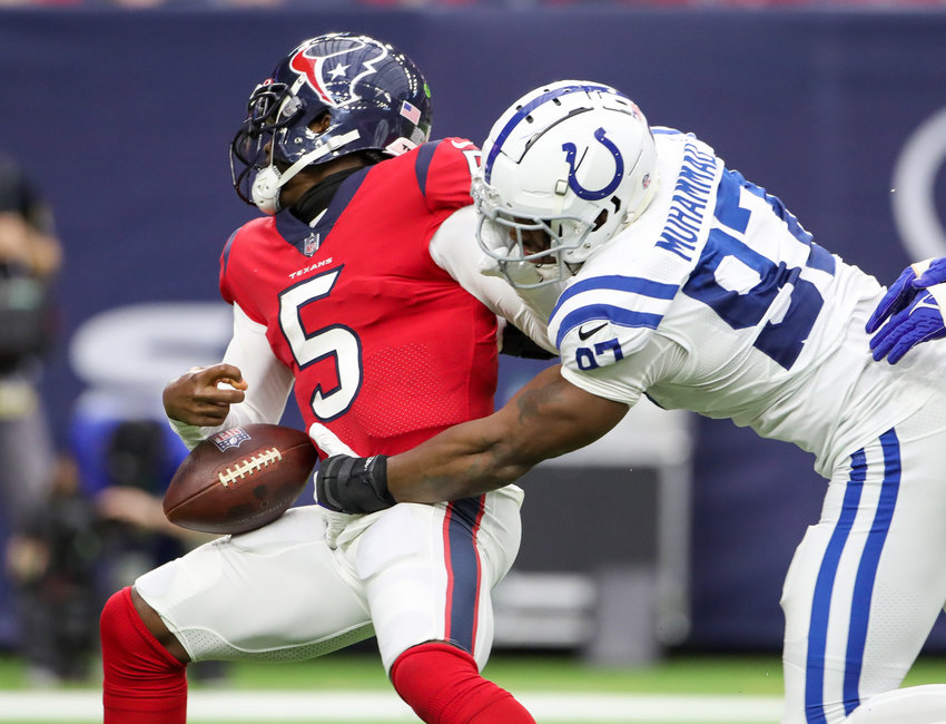 Indianapolis Colts defensive end Al-Quadin Muhammad (97) knocks the ball loose during a sack of Houston Texans quarterback Tyrod Taylor (5) during an NFL game between the Texans and the Colts on December 5, 2021 in Houston, Texas.