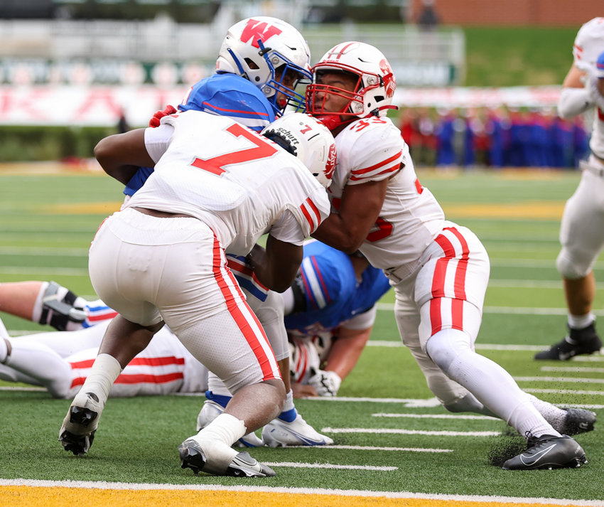 Katy Tigers defensive back Johnathan Hall (7) and linebacker Damian Neveaux (33) team up to stop Westlake Chaparrals running back Jack Kayser (33) short of the goal line during the Class 6A Division II state semifinal  game between Katy and Westlake on December 11, 2021 in Waco, Texas.