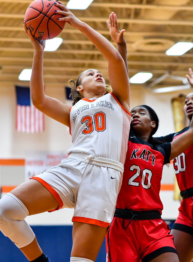 Dec 10, 2021: Seven Lakes Justice Carlton #30 drives to the basket guarded by Katy's Brianna Nelson #20 during a conference game at Seven Lakes HS. (photo by Mark Goodman / Katy Times)