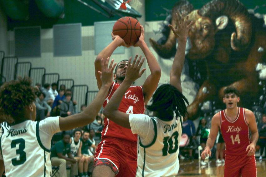 Katy&rsquo;s Dayvaughn Froe shoots a fadeaway over two Mayde Creek defenders during Wednesday&rsquo;s game at the Mayde Creek gym.